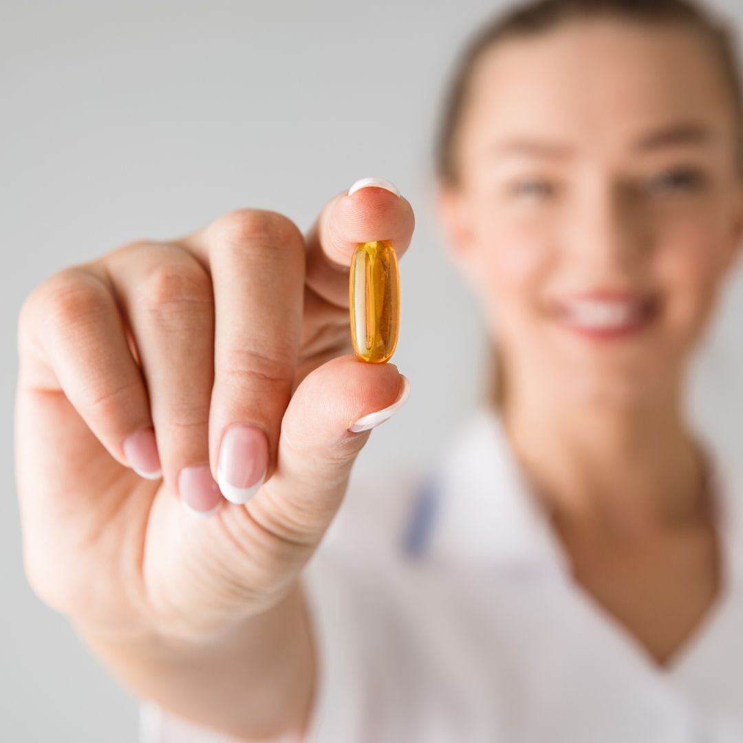 woman with vitamin supplement